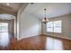 Elegant dining room with hardwood floors, chandelier, and views to living room at 20743 Nectarine Pl, Land O Lakes, FL 34637