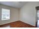 Bedroom with hardwood floors, window with blinds, and neutral walls at 20743 Nectarine Pl, Land O Lakes, FL 34637