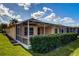 Side view of house with screened patio and hedges at 20743 Nectarine Pl, Land O Lakes, FL 34637