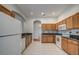 Spacious kitchen boasting wood cabinets, granite counters, and a breakfast bar at 20743 Nectarine Pl, Land O Lakes, FL 34637