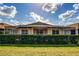 Back view of house with screened patio and hedges at 20743 Nectarine Pl, Land O Lakes, FL 34637