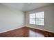 Bedroom with hardwood floors, window with blinds, and neutral walls at 20743 Nectarine Pl, Land O Lakes, FL 34637