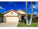 Single-story house with a two-car garage and landscaped yard at 20743 Nectarine Pl, Land O Lakes, FL 34637