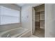 Bathroom with soaking tub and access to walk-in closet at 20743 Nectarine Pl, Land O Lakes, FL 34637