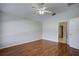 Bedroom with wood floors, ceiling fan, and access to bathroom at 20743 Nectarine Pl, Land O Lakes, FL 34637