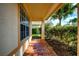 Covered front porch with tiled floor and view of landscaping at 20743 Nectarine Pl, Land O Lakes, FL 34637