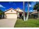 Single-story house with a two-car garage and landscaped yard at 20743 Nectarine Pl, Land O Lakes, FL 34637