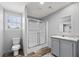 This bathroom features a glass shower, vanity with mirror, and toilet at 4304 Buena Vista Ln, Holiday, FL 34691