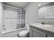 Well-lit bathroom featuring a shower and tub with a stylish vanity at 4304 Buena Vista Ln, Holiday, FL 34691