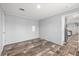 This bedroom features stylish wood-look flooring and neutral walls at 4304 Buena Vista Ln, Holiday, FL 34691
