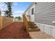 Exterior with fresh gray siding and a brand new deck and wooden fence at 4304 Buena Vista Ln, Holiday, FL 34691