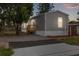 Inviting exterior with gray siding and a fresh deck, lit windows on the front of the home at dusk at 4304 Buena Vista Ln, Holiday, FL 34691