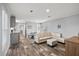 Bright living room with modern furniture, wood-look floors and view of kitchen at 4304 Buena Vista Ln, Holiday, FL 34691