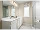 Bathroom with double vanity, large mirror, and walk-in shower at 4636 Spire Run, Lakewood Ranch, FL 34211