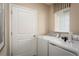 Laundry room with washer, dryer, and ample storage at 4636 Spire Run, Lakewood Ranch, FL 34211