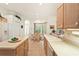 Bright kitchen with wood cabinets, tile floor, and breakfast nook at 483 Quane Ave, Spring Hill, FL 34609