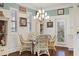 Cozy dining area with wicker chairs, chandelier, and natural light at 5632 Egrets Pl, New Port Richey, FL 34652