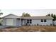 Newly renovated light gray house with white garage door at 6417 Sutherland Ave, New Port Richey, FL 34653