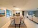 Bright dining room featuring a staged table with seating for six at 6417 Sutherland Ave, New Port Richey, FL 34653