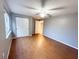 Bedroom with double door closet and wood-look flooring at 6417 Sutherland Ave, New Port Richey, FL 34653