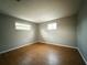 Well-lit bedroom featuring wood-look flooring at 6417 Sutherland Ave, New Port Richey, FL 34653