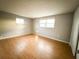 Bright bedroom with wood-look floors and neutral walls at 6417 Sutherland Ave, New Port Richey, FL 34653