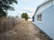 Large backyard with a wooden fence and gravel ground at 6417 Sutherland Ave, New Port Richey, FL 34653