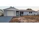 Newly renovated light gray house with white garage door at 6417 Sutherland Ave, New Port Richey, FL 34653