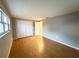 Spacious bedroom featuring wood-look floors and ample closet space at 6417 Sutherland Ave, New Port Richey, FL 34653