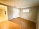 Spacious bedroom with wood-look floors and a window at 6417 Sutherland Ave, New Port Richey, FL 34653