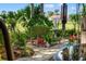 Beautiful paver walkway through lush backyard landscaping, with statue and other decoration at 8231 Coral Creek Loop, Hudson, FL 34667