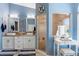The nautical bathroom includes a walk-in shower and dual sink vanity at 8231 Coral Creek Loop, Hudson, FL 34667