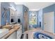 Nautical bathroom with double vanity, walk-in shower and bright blue decor at 8231 Coral Creek Loop, Hudson, FL 34667