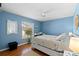 Cozy bedroom features a ceiling fan, window and comfortable bed at 8231 Coral Creek Loop, Hudson, FL 34667