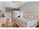 Bright bedroom featuring vaulted ceilings, wood floors and a large bed at 8231 Coral Creek Loop, Hudson, FL 34667