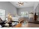Comfortable bedroom features a ceiling fan, wood floors and nautical themed decor at 8231 Coral Creek Loop, Hudson, FL 34667