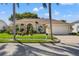 Charming single-story home with lush landscaping and a paver driveway leading to a two-car garage at 8231 Coral Creek Loop, Hudson, FL 34667