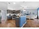 Spacious kitchen open to the living area, featuring gray cabinets, granite countertops, and stainless steel appliances at 8231 Coral Creek Loop, Hudson, FL 34667