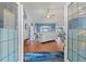Bright and airy entryway with wood floors and views into the living room at 8231 Coral Creek Loop, Hudson, FL 34667