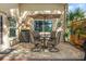 Paver patio with dining table, chairs, landscaping, privacy fence, and grill at 8231 Coral Creek Loop, Hudson, FL 34667
