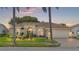 Beautiful home with a landscaped yard, a two-car garage, and a welcoming front porch at 8231 Coral Creek Loop, Hudson, FL 34667