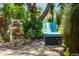 Peaceful backyard retreat with a water feature and lounge chair at 8231 Coral Creek Loop, Hudson, FL 34667