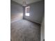 Bright bedroom with neutral carpeting, a window, and light gray walls at 8733 Southern Charm Cir, Brooksville, FL 34613