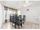 Dining area with glass table and six black chairs at 10906 New Brighton Ct, New Port Richey, FL 34654