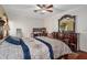 Comfortable bedroom with hardwood floors and ceiling fan at 11274 Homeway St, Spring Hill, FL 34609