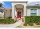 Inviting front entry with red door and landscaping at 11909 Wexford Blvd, Spring Hill, FL 34609