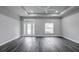 Spacious living room with dark gray vinyl plank flooring and high ceilings at 12260 Quigley Ave, Weeki Wachee, FL 34614