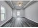 Bright living room with gray walls, vinyl plank flooring, and ceiling fan at 12260 Quigley Ave, Weeki Wachee, FL 34614