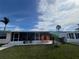 View of backyard, screened patio, and storage shed at 13809 Gene Rossi Ave, Hudson, FL 34667