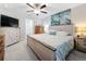 Spacious main bedroom with large bed, dresser, and TV at 16864 Red Brick Ln, Land O Lakes, FL 34638